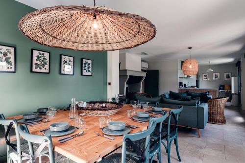 une salle à manger avec une table et des chaises en bois dans l'établissement La Maison des Pins contis, à Saint-Julien-en-Born