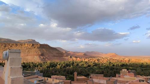 a view of a desert with mountains and trees at Home Amazigh Serenity in Tinerhir
