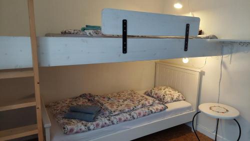 a bedroom with two bunk beds and a table at Torp in Ludvika