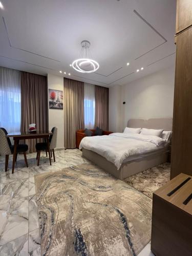 a bedroom with a large bed and a table at Zayed Plaza-زايد بلازا in Cairo