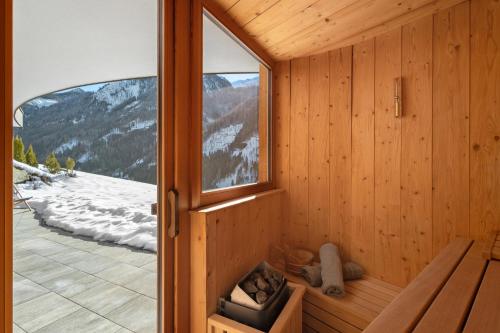 a sauna with a view of a snowy mountain at Chalet-Suite Wasser in Selva dei Molini