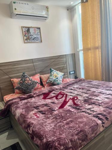 a bed with a valentines sign on top of it at Modern Luxury Deecon Valley 2BHK Flats 3Double Beds with Terrace View Tapovan Rishikesh in Rishīkesh