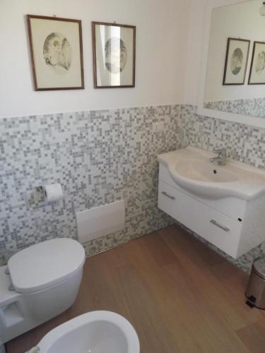 a bathroom with a toilet and a sink at La Fonda in Palau