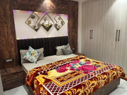 a bedroom with a bed with a colorful blanket on it at Modern Luxury Deecon Valley 2BHK Flats 3Double Beds with Terrace View Tapovan Rishikesh in Rishīkesh