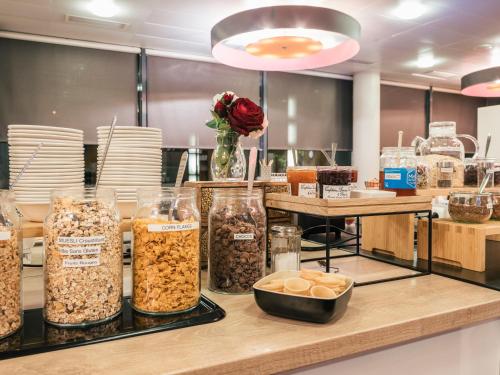 a counter with many different types of food at Holiday Inn Express Saint-Nazaire by IHG in Saint-Nazaire