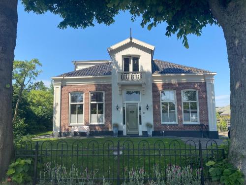 a house with a fence in front of it at Villa free standing 25 min Amsterdam 10 min beach in Akersloot