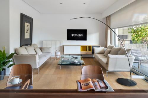 a living room with a couch and a table at Magno Apartment Ramón Carande- Private Parking included in Seville