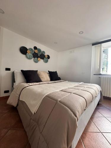 a bedroom with a large bed with two plates on the wall at Isabel’s house in Vietri sul Mare