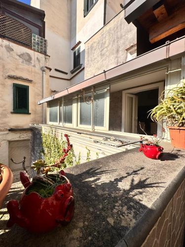 a red pig statue sitting on the side of a building at Isabel’s house in Vietri sul Mare