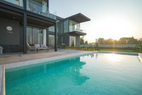 a house with a swimming pool next to a house at Sararin Luxury Villas in Nong Khai