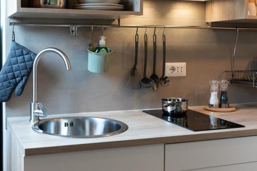 a kitchen with a sink and a counter with utensils at LittleSuiteBande NERE in Milan