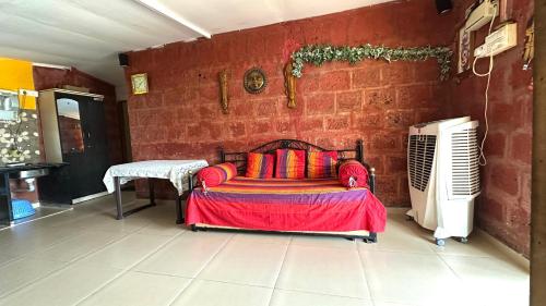 a living room with a couch and a brick wall at Turtle Beach House in Vengurla