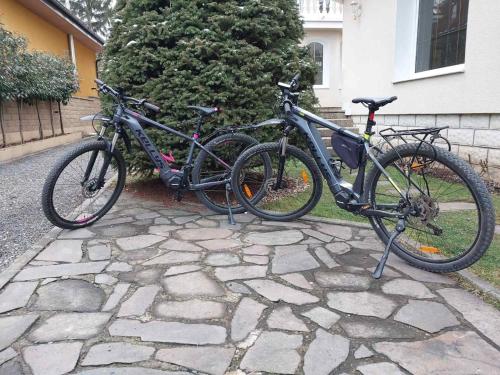 two bikes parked next to each other on a stone sidewalk at Apartmán u Toffee in Humenné