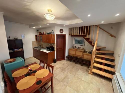 a kitchen and dining room with a table and chairs at Apartmán u Toffee in Humenné