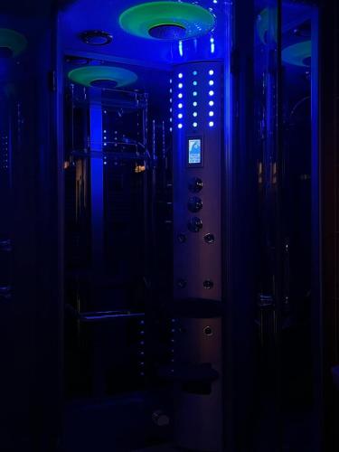 a room with a blue light in the dark at Apartmán u Toffee in Humenné