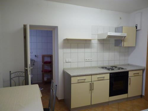 a kitchen with a stove and a counter top at Ferienwohnung Monteurwohnung in Pforzheim