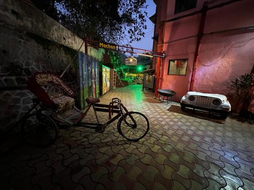 a bike parked outside of a building at night at The Saffron Suites in Sasupāda