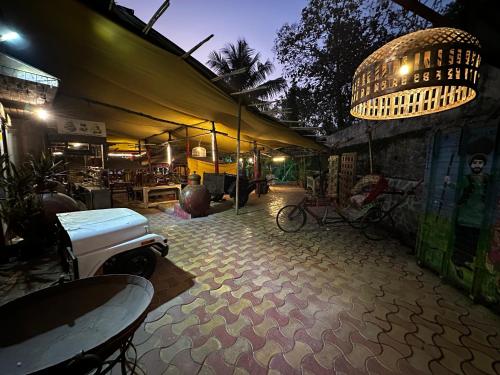 an outdoor patio with a table and a building at The Saffron Suites in Sasupāda