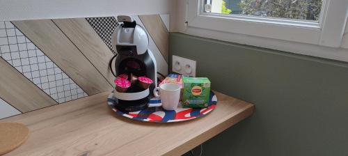 a coffee maker sitting on a counter with a plate at Votre Refuge Urbain Logement Complet pour Étudiants et Pros in Rennes