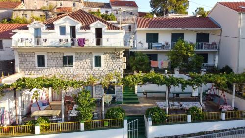 arial view of a house with trees and buildings at Soti Apartments in Kupari