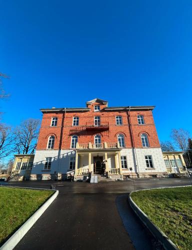 a large red brick building on a street at Hotel Montagne in Åmmeberg