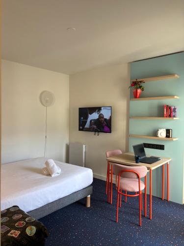 Postel nebo postele na pokoji v ubytování Appart'Hôtel Lauréades Clermont-Ferrand Centre Jaude