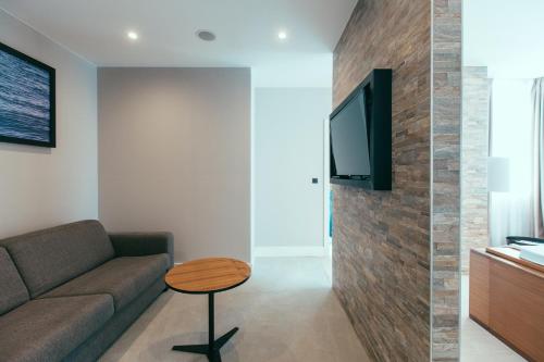 a living room with a couch and a table at Marvie Hotel & Health in Split