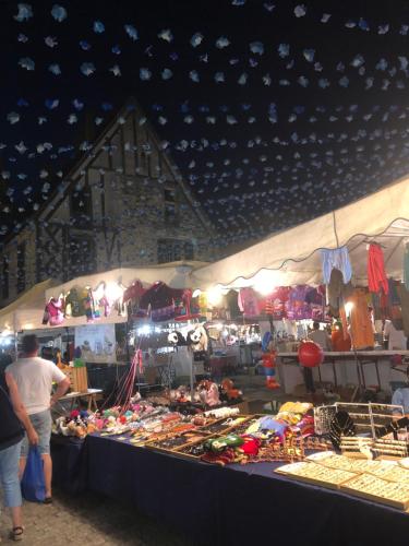 a group of people standing in front of a market at Eymet Townhouse in Eymet