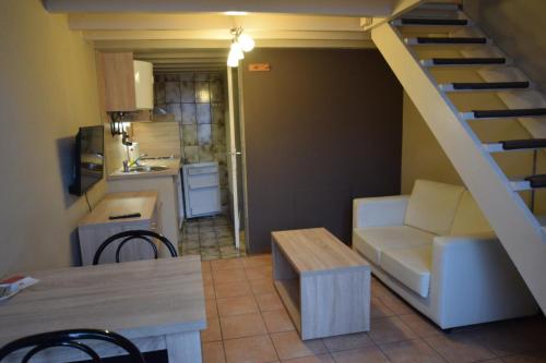 a living room with a couch and a staircase at Condo Gardens Leuven in Leuven