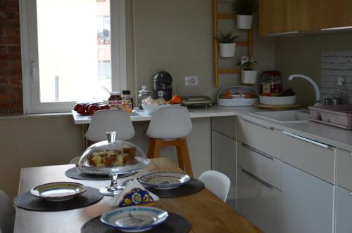 a kitchen with a table with a bowl of food on it at b&b le 4 leggende in Catania