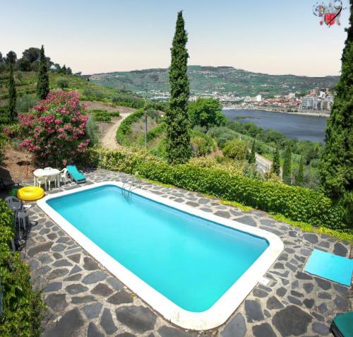 a swimming pool with a view of the water at Charming Villa with Private Pool in Lamego in Lamego
