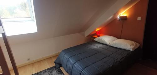 a small bedroom with a bed and a window at Evasion Gérardmer in Gérardmer