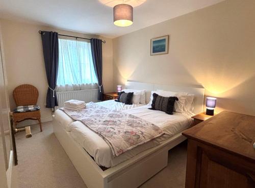 a bedroom with a bed and a window at Lock & Quay - waterfront oasis in Pevensey