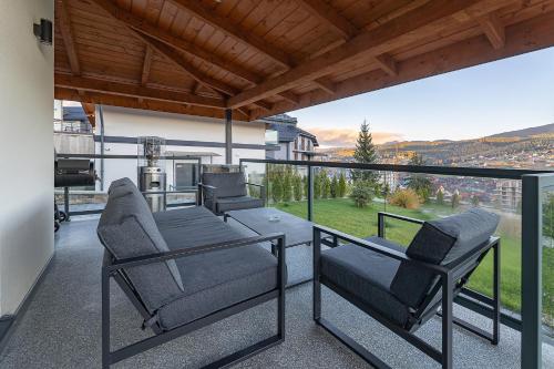 a balcony with chairs and a view of a city at Chalet 348 in Palyanytsya