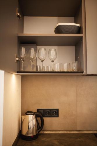 a row of wine glasses on a shelf in a kitchen at Chalet 348 in Palyanytsya