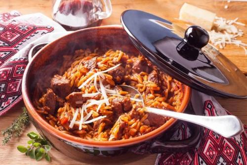 a dish of food with meat and cheese on a table at Skiathos Avaton Hotel, Philian Hotels & Resorts in Skiathos Town