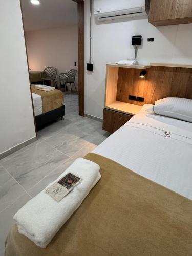 a bedroom with a bed with a towel on it at Vida Hostel in Medellín
