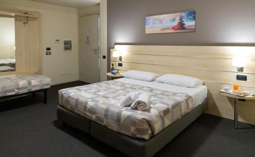 a hotel room with a bed with towels on it at Hotel Giallo in Noceto