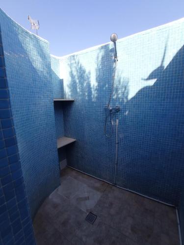 a bathroom with a shower with blue tiled walls at Casa Cristina in Vinarós
