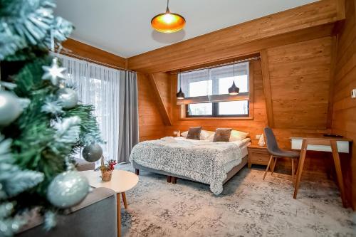 Posteľ alebo postele v izbe v ubytovaní Apartamenty Pod Tatrzańskim Niebem