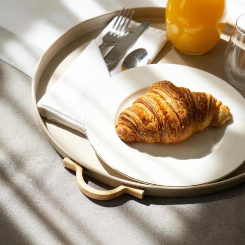a croissant on a plate on a table at Opera Boutique Hotel in Tbilisi City