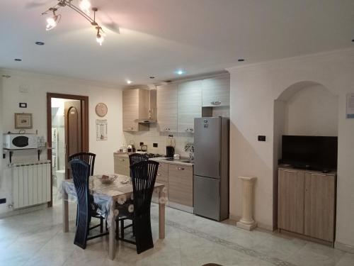 a kitchen with a table and chairs and a refrigerator at Casa Eden in Ventimiglia