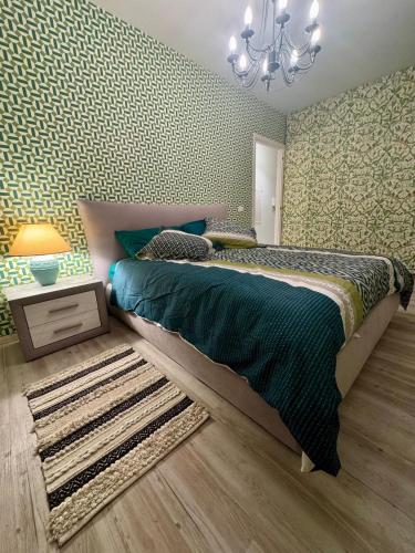 a bedroom with a large bed and a chandelier at Eden rock apartment in Grimaldi