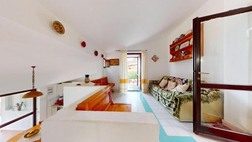 a living room with a couch and a table at Villa Marina in Campu Longu
