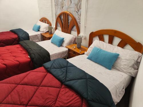 a room with three beds with pillows on them at Casa Voramar in Cullera