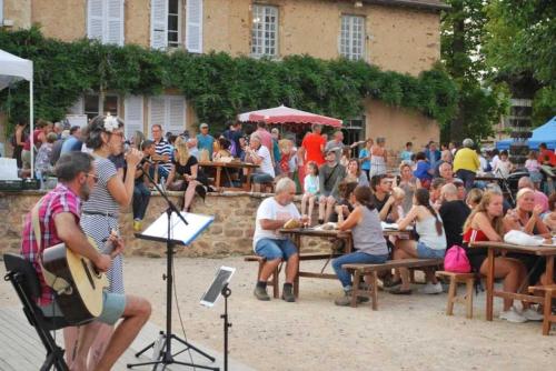 a group of people sitting at tables in front of a crowd at Chalet 3 étoiles - eeiid0 in Matour