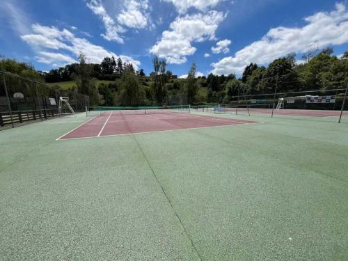 a tennis court with two tennis courts at Chalet 3 étoiles - eeiid0 in Matour