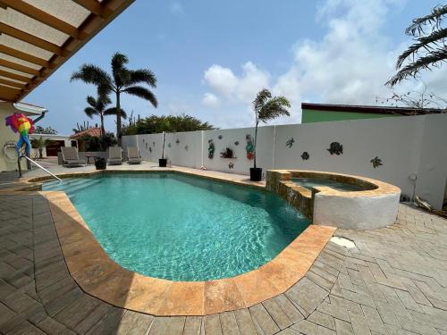 a swimming pool in the middle of a patio at Paradera Palms Apt 1 in Paradera