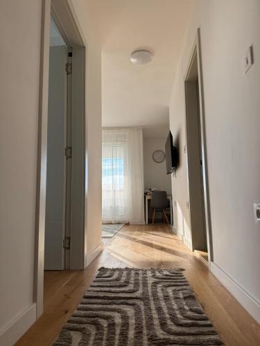 an empty hallway with a rug on a wooden floor at Riverside in Sremska Mitrovica
