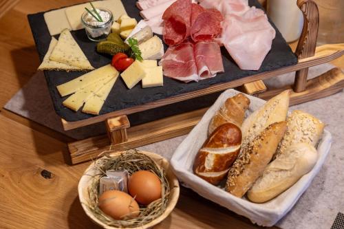 a table with two trays filled with different types of food at Chalet Berg in Selva dei Molini